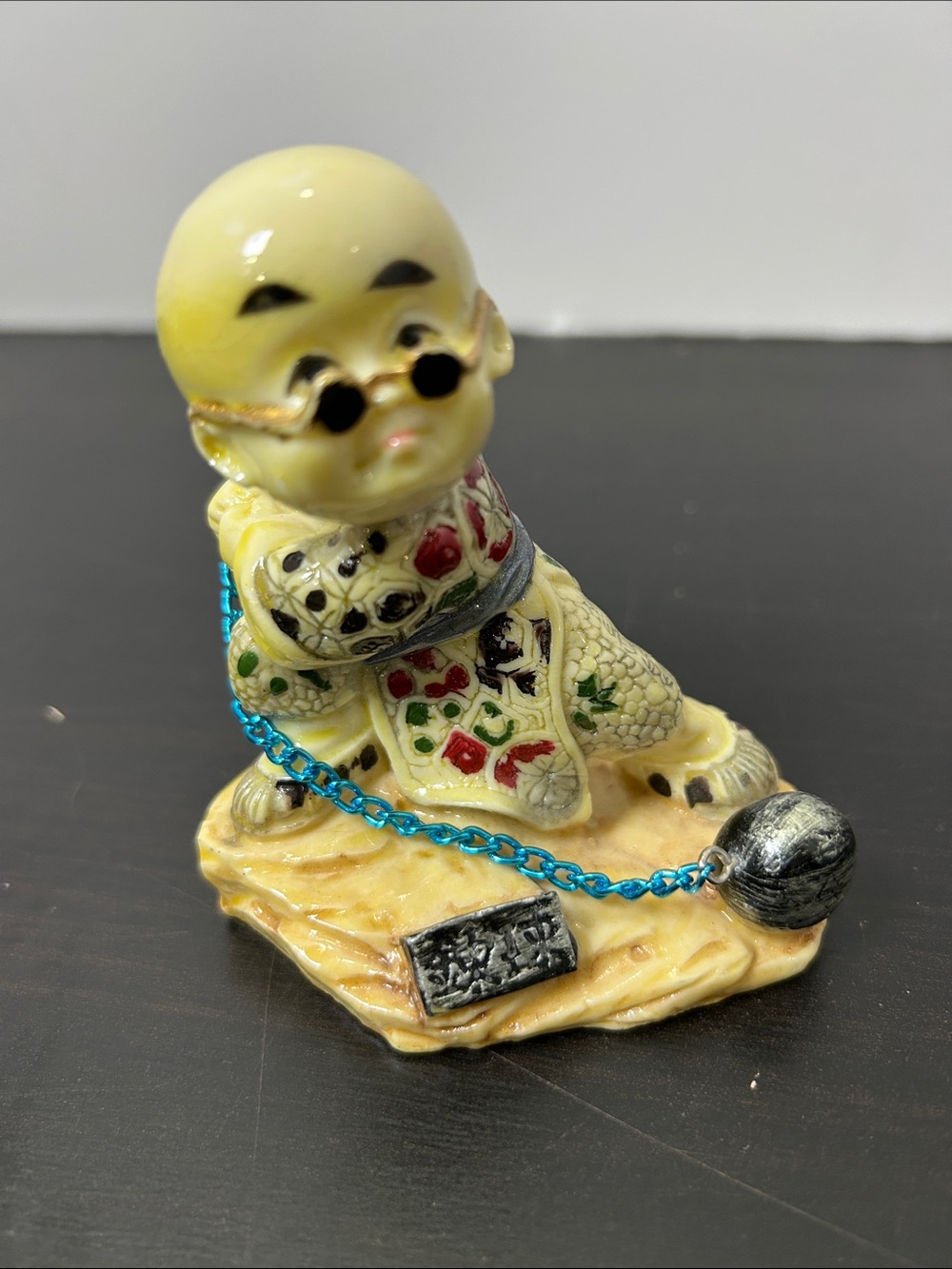 Vintage Asian monk boy figurine with blue chain and ball